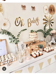 a baby shower party with cupcakes, cakes and decorations