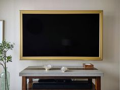 a large blackboard mounted on the wall above a table with two bowls and cups