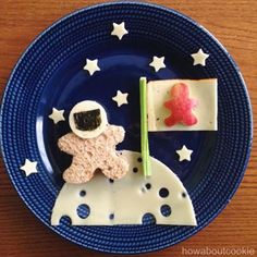 a plate that has some food on it with stars and moon in the sky around it