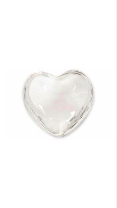 a glass heart shaped dish on a white background