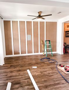 an empty room with hard wood floors and wall paneling in the process of remodeling