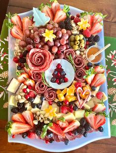 a platter filled with fruit and veggies on top of a table