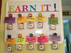 a bulletin board with money and magnets on it that reads earn it, earn it