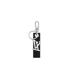 a black leather key chain with the letter l on it's front and back ends