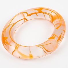 Rare English designer Marlene McKibbin Lucite or Acrylic bracelet bangle. This bracelet is transparent frosted with an open coiled design and has an orange acrylic screening ink application.  Measurements: inside across is 2.75 in wide x 2.50 in deep (7 x 6.4 cm) - width is 0.82 in (2 cm) - inner circumference is 8.25 in (21 cm). It will best fit a Medium-sized wrist of 7.07 in circumference maximum (18 cm).  Reference: Check the last two pictures. This special design was pictured in "Classic Pl Acrylic Rod, Acrylic Bracelet, Lucite Jewelry, Acrylic Jewelry, English Design, Acrylic Jewellery, Bracelet Bangle, Special Design, Bergdorf Goodman