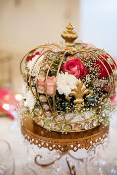 a crown with flowers in it sitting on a table