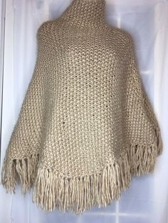 Rue21 Crochet Knitted Beige Poncho With High Neck And Fringe One Size Fits All. Made with chunky acrylic yard From top of neck to bottom of fringe measures 32” Neck opening measures 9.5” Widest Measures 38” Condition is Pre-owned. Thanks for looking Beige Knit Poncho One Size, Beige Knit Poncho, One-size Beige Knit Poncho, Beige Crochet Poncho For Fall, Fall Crochet Beige Poncho, Hand Knitted Beige Poncho For Fall, Hand-knitted Beige Poncho For Winter, Hand Knitted Beige Poncho For Winter, One Size Knitted Acrylic Poncho