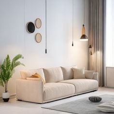 a living room with a couch, rug and two lamps on the wall above it