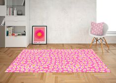 a living room with pink and yellow rugs on the floor next to a chair