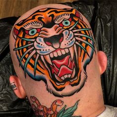 a man with a tiger tattoo on his head