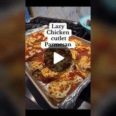 a pizza sitting on top of a pan covered in cheese and toppings with the words lazy chicken cutt pames