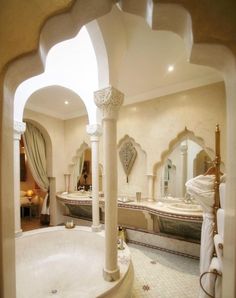 a large bathroom with two sinks and a bathtub in the middle of the room