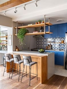 a kitchen with blue cabinets and wooden floors