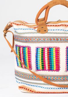 Travel in style with this ultra-bohemian weekender travel bag. A colorful statement piece featuring embroidered details, a zip-top closure, and suede trim. The large carry-all size is perfect for last-minute getaways. Embroidered Stitch details Zip-top closure Suede leather top handles Leather shoulder strap Bohemian weekender bag Dimensions: 24" X 17 3/4"Style: DR-8474 Bohemian Canvas Hobo Bag For Travel, Bohemian Hobo Bag With Braided Handles For Travel, Multicolor Bohemian Shoulder Bag For Travel, Embroidered Canvas Shoulder Bag For Travel, Bohemian Rectangular Shoulder Bag With Zipper, White Bohemian Hobo Bag For Travel, Multicolor Shoulder Bag With Luggage Sleeve For Trips, Bohemian Canvas Tote Hobo Bag, Bohemian Canvas Hobo Tote Bag