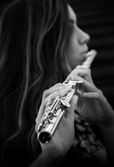 a woman holding a flute in her hands