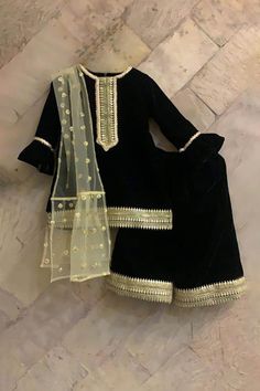 Black velvet kurta with butti embroidered yoke sleeves, and hem.  Comes with palazzo and a gold net dupatta. Pattern: Embroidered Fabric: Velvet, Dupatta : Net Embroidered motifs on dupatta Occasion: Festive & Wedding Care: Dry clean only Fit: Relaxed Velvet Kurta, Kurti Palazzo Set, Beautiful Frocks, Eastern Dresses, Kurta Palazzo Set, Kurti Palazzo, Kids Frocks Design