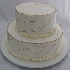 a three layer white cake with gold sprinkles on the top and bottom