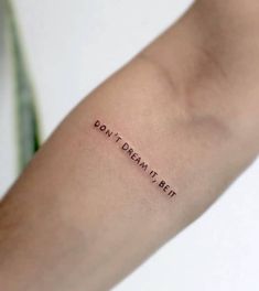 a person with a tattoo on their arm that says don't dream it bet