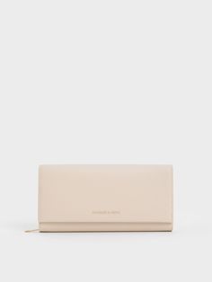 You can never go wrong with a classic neutral, and this iteration of the long wallet is perfect. The pristine oat finish enhances the clean, unembellished exterior, especially when punctuated with minimal gold-toned hardware. Offering style alongside functionality, the elongated silhouette opens up to generous card slots, bill slots and a spacious zippered compartment for all your coins. Modern Beige Wallets For Everyday Use, Modern Beige Wallet For Everyday Use, Classic Beige Clutch For Daily Use, Modern Everyday Beige Wallets, Chic Cream Everyday Wallets, Elegant Cream Wallet For Everyday Use, Elegant Cream Wallets For Everyday Use, Elegant Beige Wallets For Everyday Use, Classic Cream Wallet