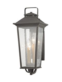 Invite rustic charm to your front entrance with this medium scale outdoor wall mount light. Crafted from hand worked iron, the tapered lantern design features seeded glass panels and houses 3 candelabra lights to brighten outdoor walkways. An aged pewter finish adds to the classic appeal of this outdoor wall fixture. allen + roth Prospect Hill 7-in W 3-Light Pewter Transitional LED Wall Sconce | WL-2110 Shutter Styles, Exterior Lights, Outdoor Wall Mounted Lighting, Troy Lighting, Lantern Design, Allen Roth, Transitional Wall Sconces, Outdoor Wall Lantern, Seeded Glass