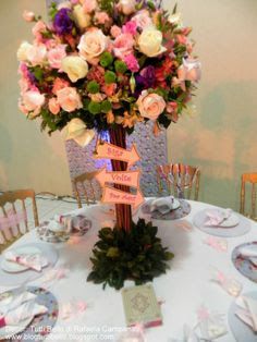 there is a table set up with flowers and place settings for the guests to sit at