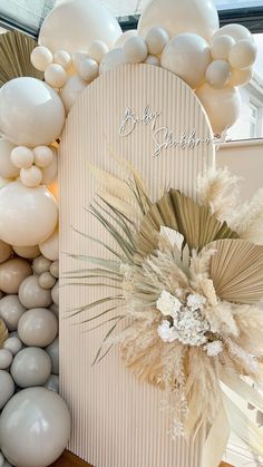 balloons and flowers are on display in front of a backdrop