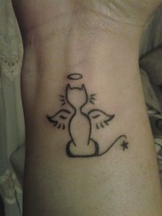 a small tattoo on the ankle of a cat with wings and an angel's tail