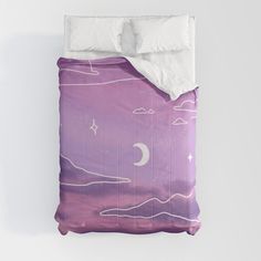 a bed with a purple comforter and white pillows