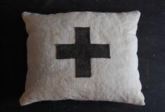 a white pillow with a black cross on it