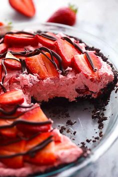 there is a pie with strawberries on it and chocolate drizzled over the top