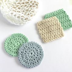 three crocheted coasters are sitting next to each other on a white surface