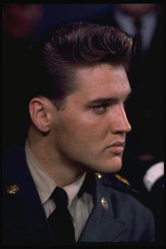 a man in uniform looking off into the distance