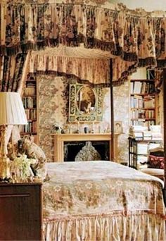 a bed sitting in a bedroom next to a fire place under a canopy over a fireplace