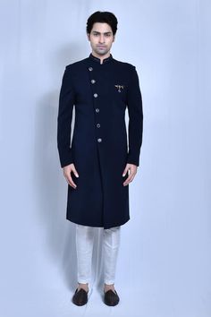 Navy blue full sleeves asymmetric placket plain sherwani with hand embroidered band collar. Paired with a white straight pant. - Aza Fashions Traditional Blue Sherwani For Semi-formal Occasions, Blue Traditional Sherwani For Semi-formal Occasions, Semi-formal Blue Sherwani With Zari Work, Blue Embroidered Sherwani For Semi-formal Occasions, Semi-formal Embroidered Blue Sherwani, Semi-formal Blue Embroidered Sherwani, Traditional Bandhgala For Semi-formal Events, Blue Semi-formal Traditional Wear With Long Sleeves, Blue Semi-formal Long-sleeve Traditional Wear