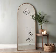 a mirror sitting next to a table with a potted plant