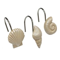 three metal hooks with seashells attached to them