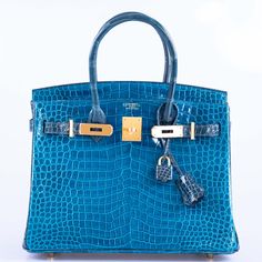 The HSS Birkin from Hermès embodies the epitome of luxury and exclusivity. Available only to a select clientele, this highly desired accessory represents a rare acquisition. The exterior is expertly crafted using a delicate blend of Blue Izmir and Blue Colvert Porosus crocodile, accompanied by radiant brushed gold hardware. With its well-balanced 30cm size, this Birkin offers a perfect blend of practicality and sophistication, making it an ideal choice for both daily use and a touch of refinement. Indulge in timeless elegance with the HSS Birkin from Hermès. Made exclusively for our most discerning customers, this coveted accessory is a rare find. The exterior boasts masterful craftsmanship, with a stunning combination of Blue Izmir and Blue Colvert Porosus crocodile, complemented by luxur Birkin Bags, Birkin Handbags, Favorite Handbags, Hermes Birkin 30, Luxury Purses, Birkin 25, Fancy Bags, Cute Purses