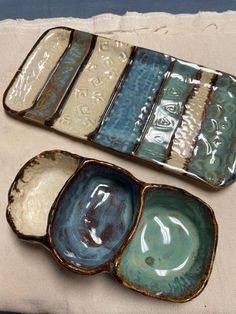 three ceramic dishes sitting on top of a table