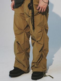 Editor's NoteCord.'s crease nylon banding pants are the new summer version of one of the brand's steady seller item. With a light and crispy nylon fabric, you can easily wear it during the summer season. It has a distinctive design point of crease details on both front and back, and has a color blocking detail near the hem of the back. With elastic waistband and string, it has a comfortable wear that fits various body types, and has an adjustable silhouette with strings and stoppers on the hem. Style it with various items for a young streetwear outfit. - Crease detail on front and back- Elastic waistband with string- Color block detail on the back- Adjustable hem with string and stopperMeasurements (in.)M/LWaist: 14.17 in / 14.57 inCrotch: 14.57 in / 14.96 inThigh: 14.17 in / 14.57 in Urban Parachute Pants With Elastic Waistband For Summer, Urban Style Summer Parachute Pants With Elastic Waistband, Baggy Nylon Techwear Pants, Spring Streetwear Nylon Cargo Pants, Urban Parachute Pants For Outdoor In Spring, Spring Nylon Parachute Pants For Outdoor, Nylon Techwear Bottoms With Elastic Waistband, Techwear Bottoms With Elastic Waistband In Nylon, Urban Nylon Bottoms For Summer