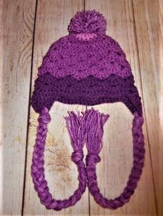 Very cute purple hat with pop pom. I bet your child will want to wear this hat all winter. Made with 4 ply acrylic yarn. Hat circumference is approx 15 inches. Will fit most toddlers. Hand washing and dry flat is recommended but can be machine washed on delicate and tumble dry low. READY TO SHIP Please contact me for international shipping rates Adjustable Purple Yarn Crochet Hat, Adjustable Purple Beanie For Winter, Adjustable Purple Crochet Yarn Hat, Purple Crochet Yarn Hat, Playful Purple Adjustable Hat, Adjustable Hand Knitted Purple Crochet Hat, Adjustable Hand-knitted Purple Hat, Adjustable Hand-knitted Purple Crochet Hat, Adjustable Purple Crochet Hat