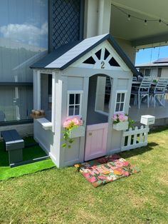 Cubby house with mail box and window for kids coffee maker. Painted in grey with a pink door and white trims. Pink flowers in the window sills and a floral door mat. Baby Penelope, Kmart Australia, House Bedroom Ideas, Backyard Adventure