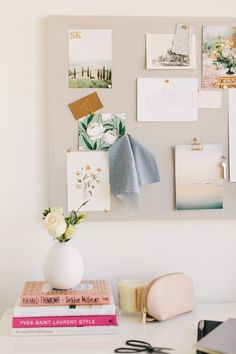 a white desk topped with books and pictures