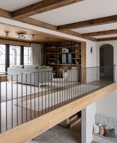 an open living room with wood and metal railings