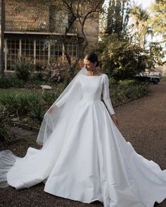 a woman in a white wedding dress and veil