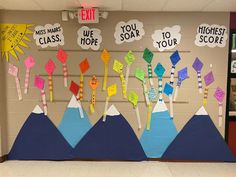 a classroom door decorated with colorful paper cutouts