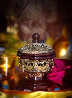 there is steam rising out of the top of a bowl on a table with other items