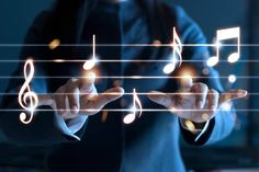 a man in a suit is touching music notes on his fingers and pressing them down