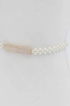 This elegant Rhinestone Buckle Pearl Elastic Belt is a must-have accessory for any outfit. The rhinestone buckle adds a touch of sparkle, while the elastic band ensures a comfortable and secure fit. Perfect for any occasion, this belt will add a classic and sophisticated touch to your wardrobe. One Size / AdjustableWidth - 0.75"Length - 28.25"Composition - PVCLead & Nickel Compliant Elegant Bedazzled Formal Jewelry, Elegant Formal Bedazzled Jewelry, Elastic Belt, Audrey Hepburn, Elastic Band, Must Haves, Composition, Sparkle, Buckle