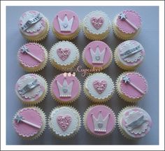 cupcakes decorated with pink and white frosting are arranged in the shape of crowns