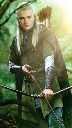 a man with long hair holding a bow and arrow in his hand while standing in the woods